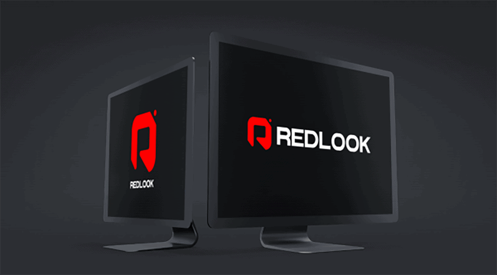 New RedLook logo displayed on dual computer screens for brand refresh.