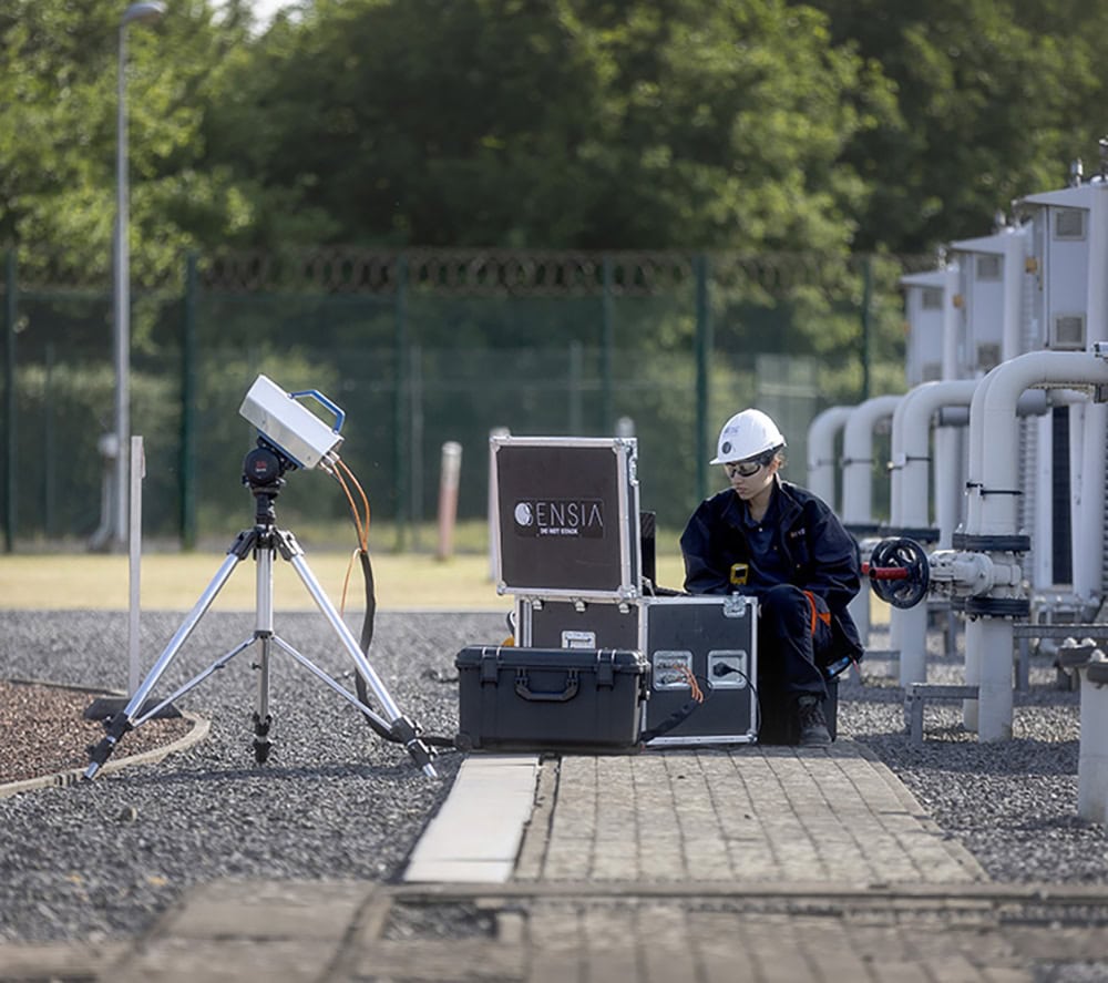 Technician using monitoring equipment at SENSIA for environmental analysis.